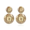 Gouden Glitter Oorbellen Larissa Logo